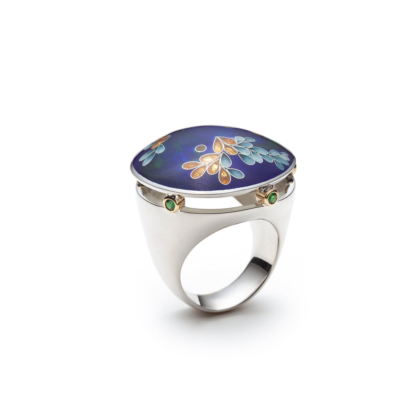 Silver ring with a blue stone featuring floral designs on a white background