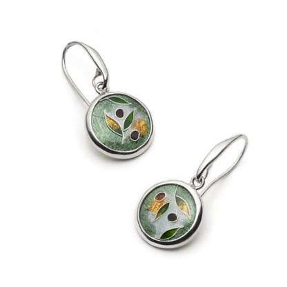 Pair of silver earrings with green circular designs on a white background
