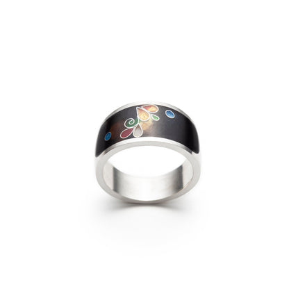 Silver ring with a black band featuring colorful floral design on a white background
