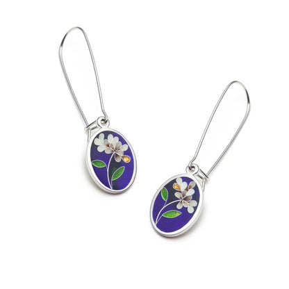 Pair of floral earrings with purple and white flowers on a white background