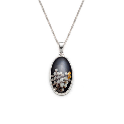 Necklace with an oval pendant featuring small flowers on a white background