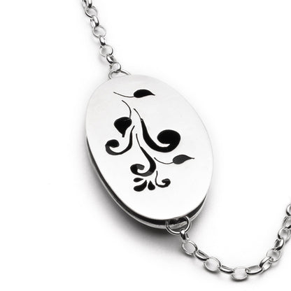 Silver necklace with a decorative pendant on a white background