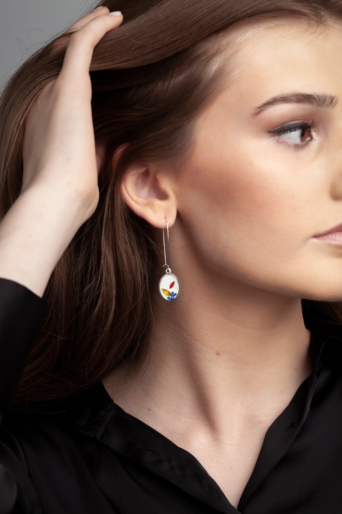 White oval earrings with golden leaves
